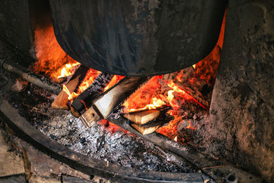 Wood burning in fire under big pot