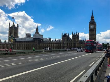 View of city street and buildings against sky