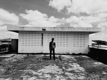 Full length rear view of man standing against building