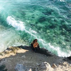 High angle view of woman sitting at beach