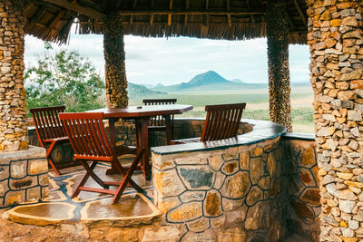 Table and chairs at an outdoor pub with a scenic lookout at tsavo east national park in kenya