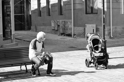 Grandfather with mask on street in city waiting the grandson