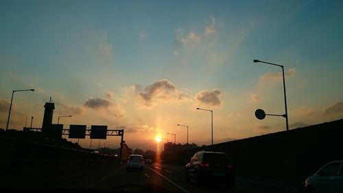 Car on road at sunset