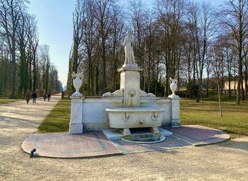 Statue in park against sky