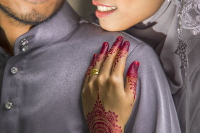 Close-up of couple holding hands