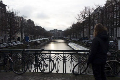 Man cycling on bridge in city