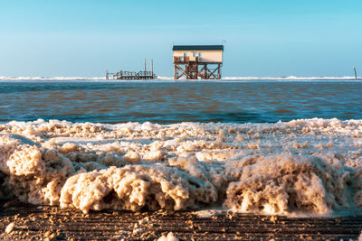 Pile dwelling on the beach of sankt peter-ording in germany.