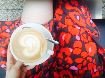 Close-up of hand holding coffee cup