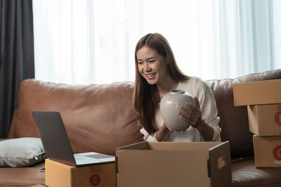 Portrait of young woman using digital tablet at home