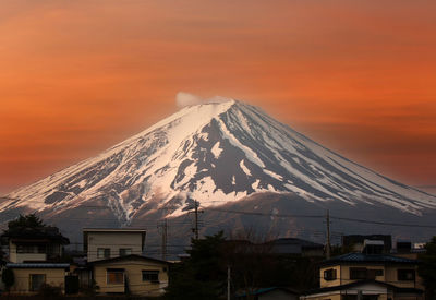 Scenic view of snowcapped mountains against sky during sunset