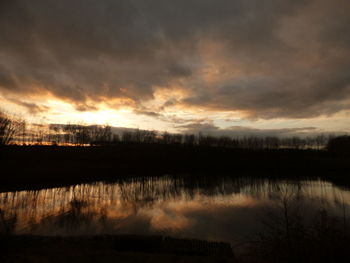 Scenic view of lake against sky during sunset