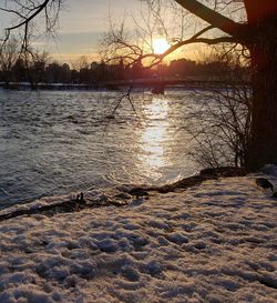 Scenic view of lake against sky during winter