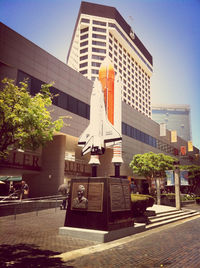 Buildings in city against blue sky