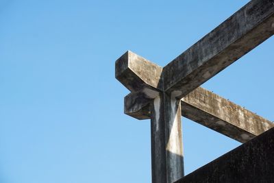 Low angle view of cross against clear blue sky