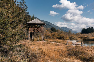 Beautiful autumn scenery with observation post by a lake in mountains