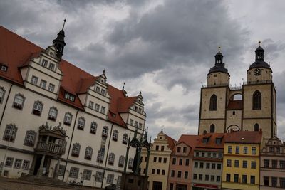 Low angle view of buildings in city against sky