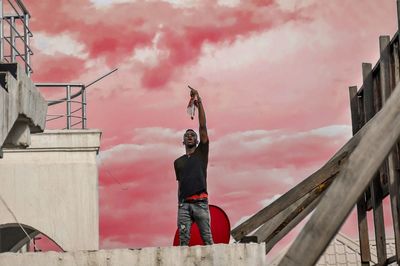 Full length of man standing against sky during sunset