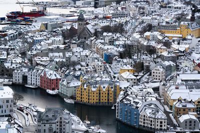 High angle view of townscape by river in city