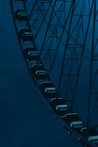 Illuminated ferris wheel against sky at night