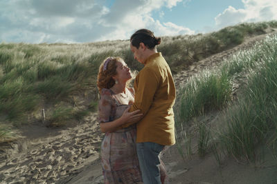 Rear view of couple standing on land