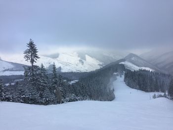 Scenic view of snowcapped mountains against sky