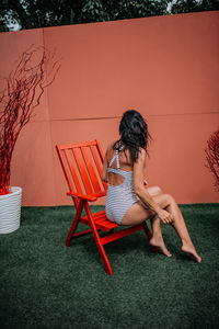 Full length of woman sitting on chair