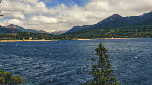 Scenic view of sea and mountains against sky