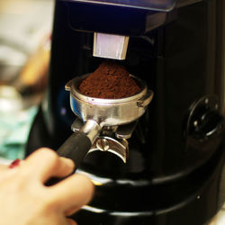 Close-up of hand holding coffee cup