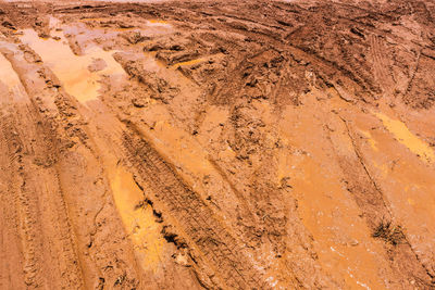 High angle view of tire tracks on dirt road