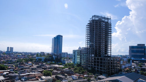 Modern buildings in city against sky