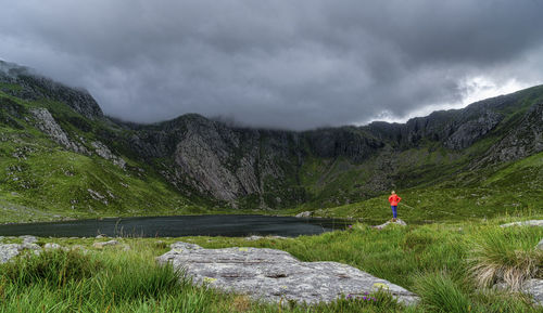 Scenic view of lake by mountains against sky