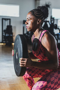 Side view of man exercising in gym