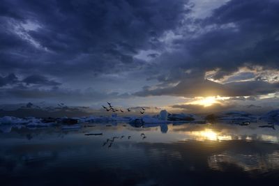 Scenic view of lake against sky during sunset