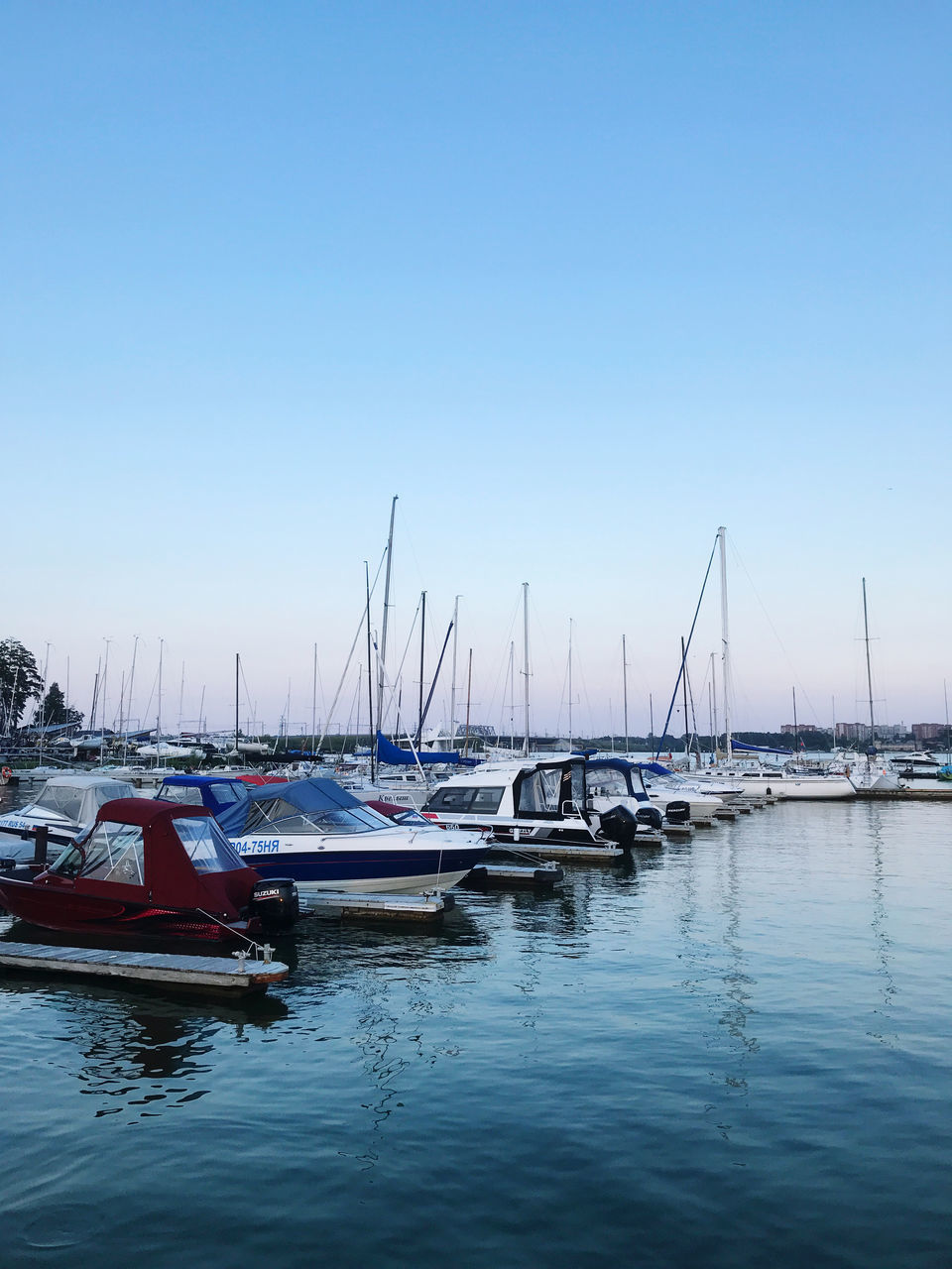 SAILBOATS MOORED AT HARBOR