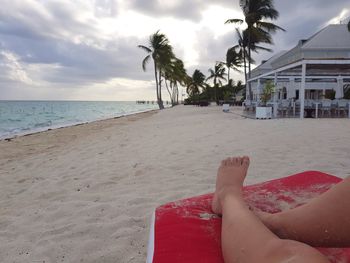 Low section of woman relaxing on beach