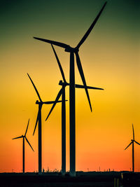 Low angle view of windmill against sky during sunset