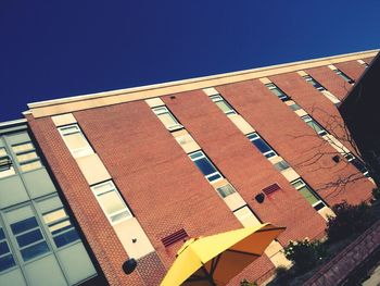 Low angle view of buildings against blue sky