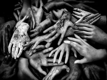 High angle view of people touching stack