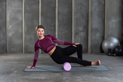 Young woman exercising in gym