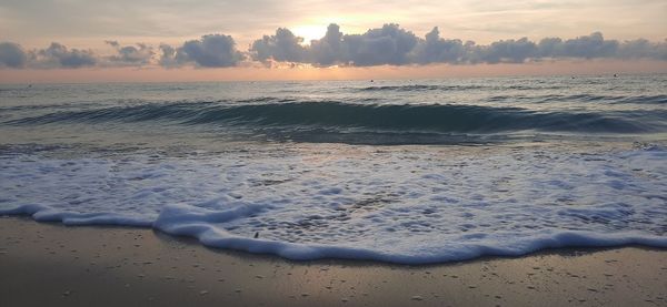 Scenic view of beach against sky during sunset