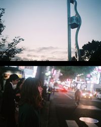 Crowd on road against sky at night