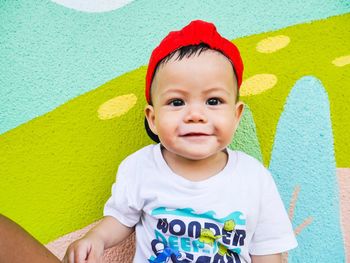 Portrait of cute boy against wall