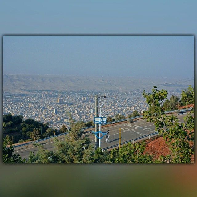 building exterior, built structure, architecture, sea, water, tree, high angle view, house, sky, clear sky, plant, horizon over water, blue, day, green color, city, residential structure, copy space, auto post production filter, nature