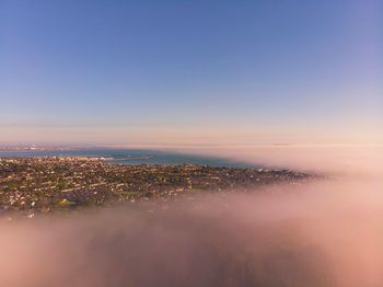 Aerial view of city against sky during sunset