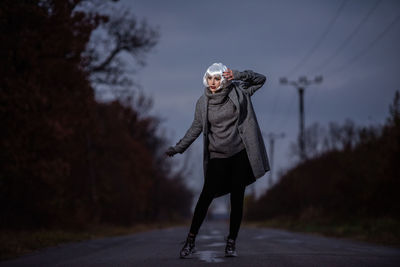 Full length of person standing on road in winter