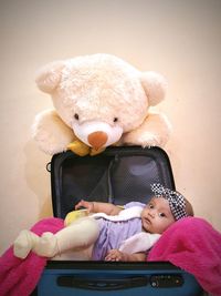 Baby girl sitting in front of face at home