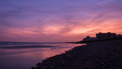 View of beach against cloudy sky