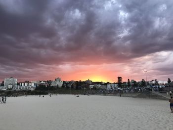 Panoramic view of people against dramatic sky