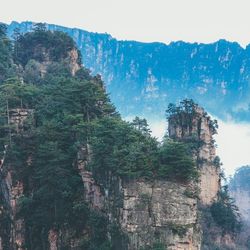 Low angle view of rocky mountains against sky