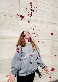 Woman standing against wall